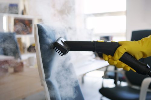 persona-servicio-limpieza-profesional-que-usa-limpiador-vapor-oficina
